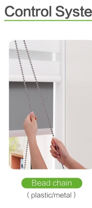 Hand pulling a metal bead chain on a roller blind.