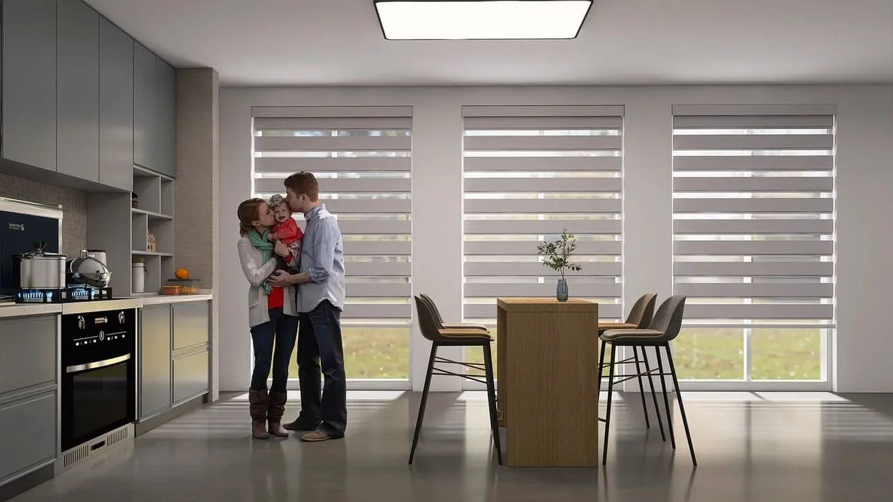 Light-filtering motorised roller shades in a calm family living room.