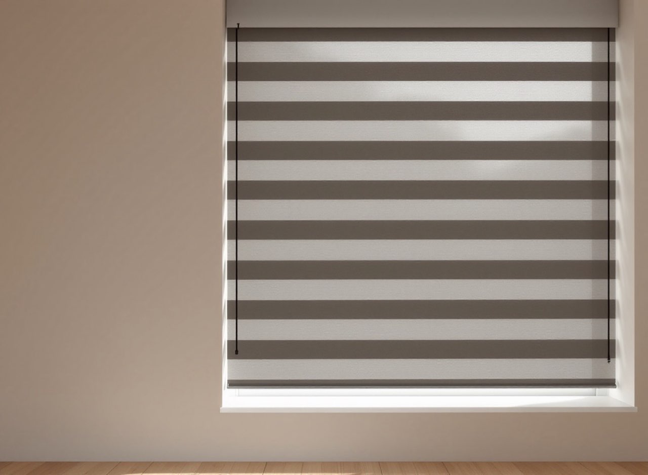 Day-night zebra blind with alternating sheer and solid bands, fully lowered.