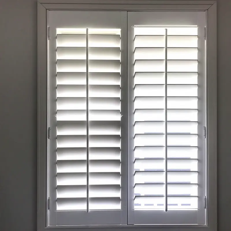 White plantation shutters with the louvres part-tilted, showing the difference between open and closed.